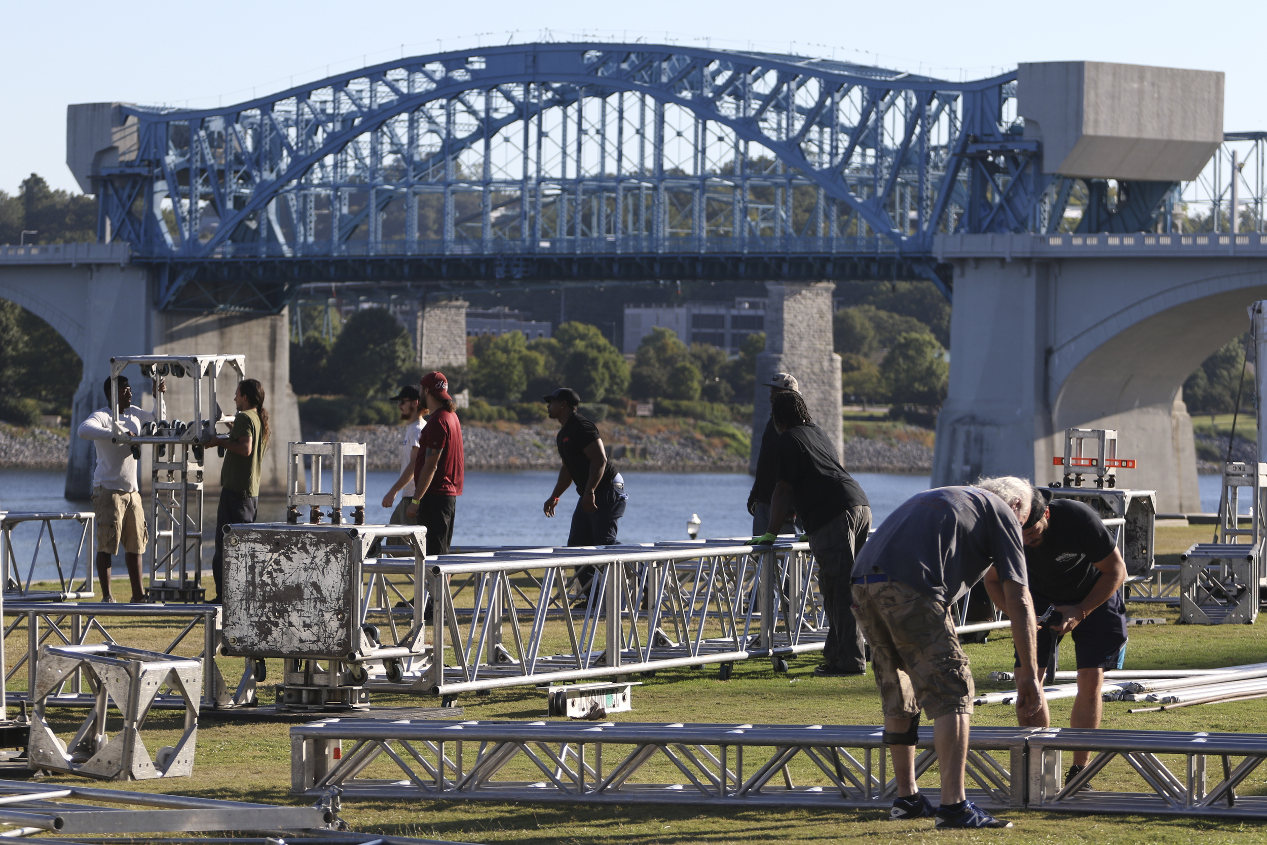 Staff Photo by Dan Henry / The Chattanooga Times Free Press- 9/29/16. Workers with the American Stage Company, set up a 60'x20' stage on Thursday, September 29, 2016, along the riverfront in preparation for this weekend's 10th annual 3 Sisters Bluegrass Festival.