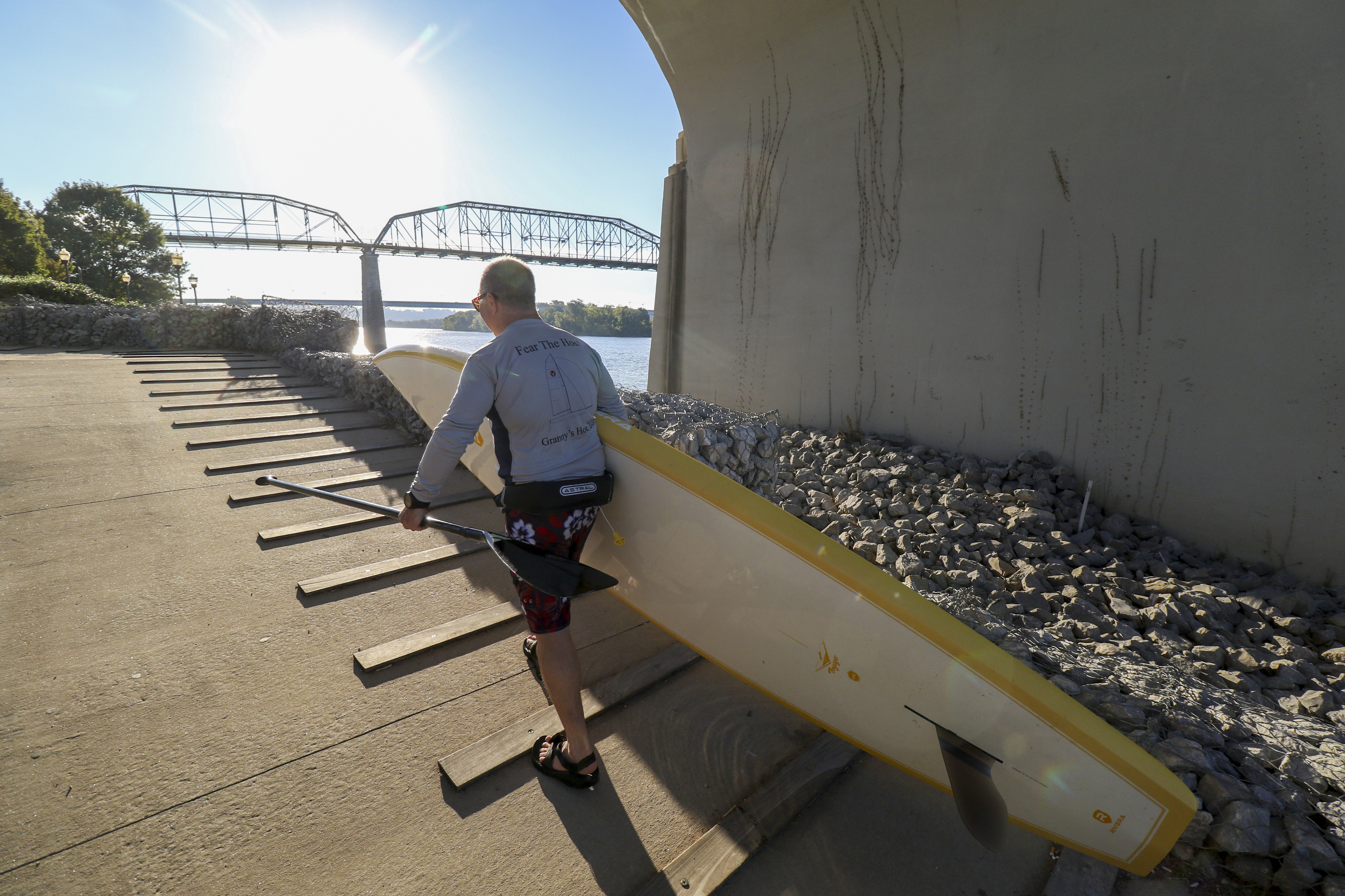 Staff Photo by Dan Henry / The Chattanooga Times Free Press- 9/29/16. Andy Parker returns to the Coolidge Park put-in under the Market Street Bridge after paddle boarding on the Tennessee River before work on Thursday, September 29, 2016.