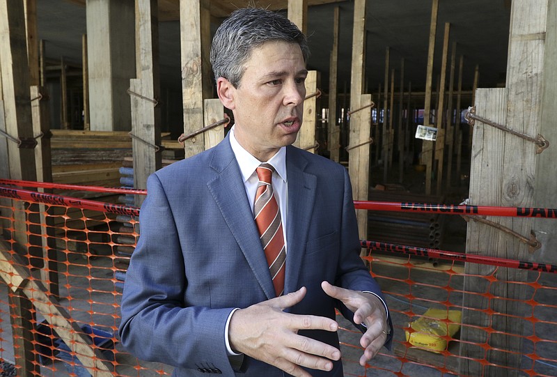 Chattanooga City Mayor Andy Berke speaks about progress and a change in tax incentives for future downtown builds as construction continues on the concrete structural frame of the 728 Market Street building on Monday, July 18, 2016.