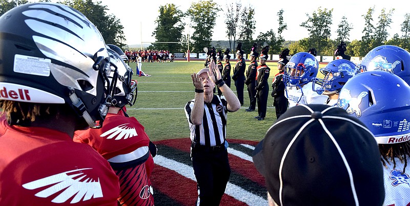 Team captains watch as the referee tosses the coin.  The Red Bank Lions visited the Signal Mountain Eagles in TSSAA football action on Friday September 30, 2016.