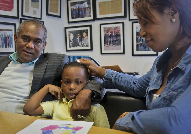
              Raphael and Maribel Martinez comfort their son Andy after a press conference at their lawyer's office, Friday Sept. 30, 2016, in New York.  Maribel Martinez has filed a lawsuit against JetBlue Airways for mixing up Andy with another boy and flying him to the wrong city.  (AP Photo/Bebeto Matthews)
            