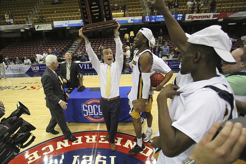 
              FILE - In this March 7, 2016, file photo, Chattanooga head coach Matt McCall celebrates with his team after winning the Southern Conference men's basketball championship in an NCAA college basketball game against East Tennessee State University in Asheville, N.C. The Southern Conference will keep four league championships in North Carolina despite the NCAA and the ACC withdrawing championships because of the state law restricting rights of LGBT people. The championships are: men's soccer in Greensboro, men's and women's basketball in Asheville and men's golf in Pinehurst.  (AP Photo/Ben Earp, File)
            