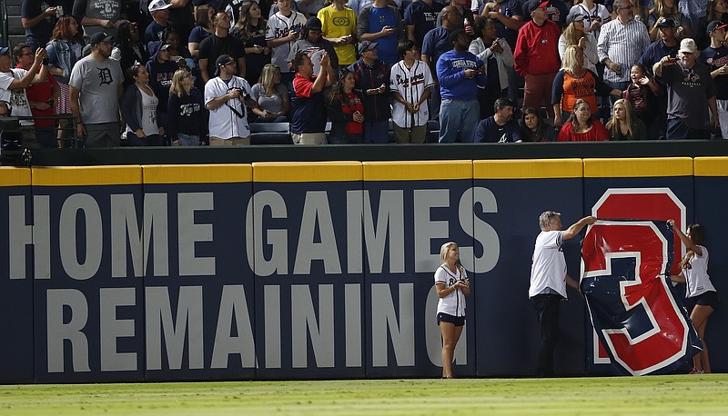 Former Atlanta Braves center fielder Dale Murphy pulls the No. 3 off the left field wall to reveal only two games left to be played at Turner Field after the fifth inning of a baseball game against the Detroit Tigers, Friday, Sept. 30, 2016, in Atlanta. The Braves plans to move to their new ballpark next season. (AP Photo/John Bazemore)