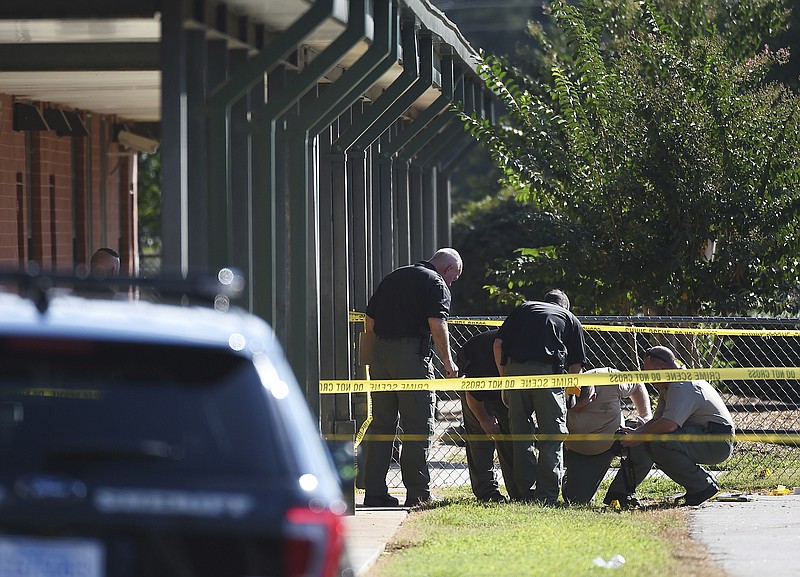 
              FILE - In this Wednesday, Sept. 28, 2016 file photo, members of law enforcement investigate an area at Townville Elementary School in Townville, S.C. A 6-year-old boy who was critically wounded in the school shooting died Saturday, Oct. 1, 2016, days after a 14-year-old boy opened fire on the school playground, authorities said. Jacob died about 1 p.m. Saturday, and an autopsy will be done Sunday, Anderson County Coroner Greg Shore said. (AP Photo/Rainier Ehrhardt, File)
            