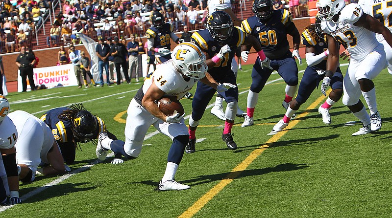 UTC running back Derrick Craine scored three touchdowns in the third-ranked Mocs' 37-7 Southern Conference win over East Tennessee State on Saturday.