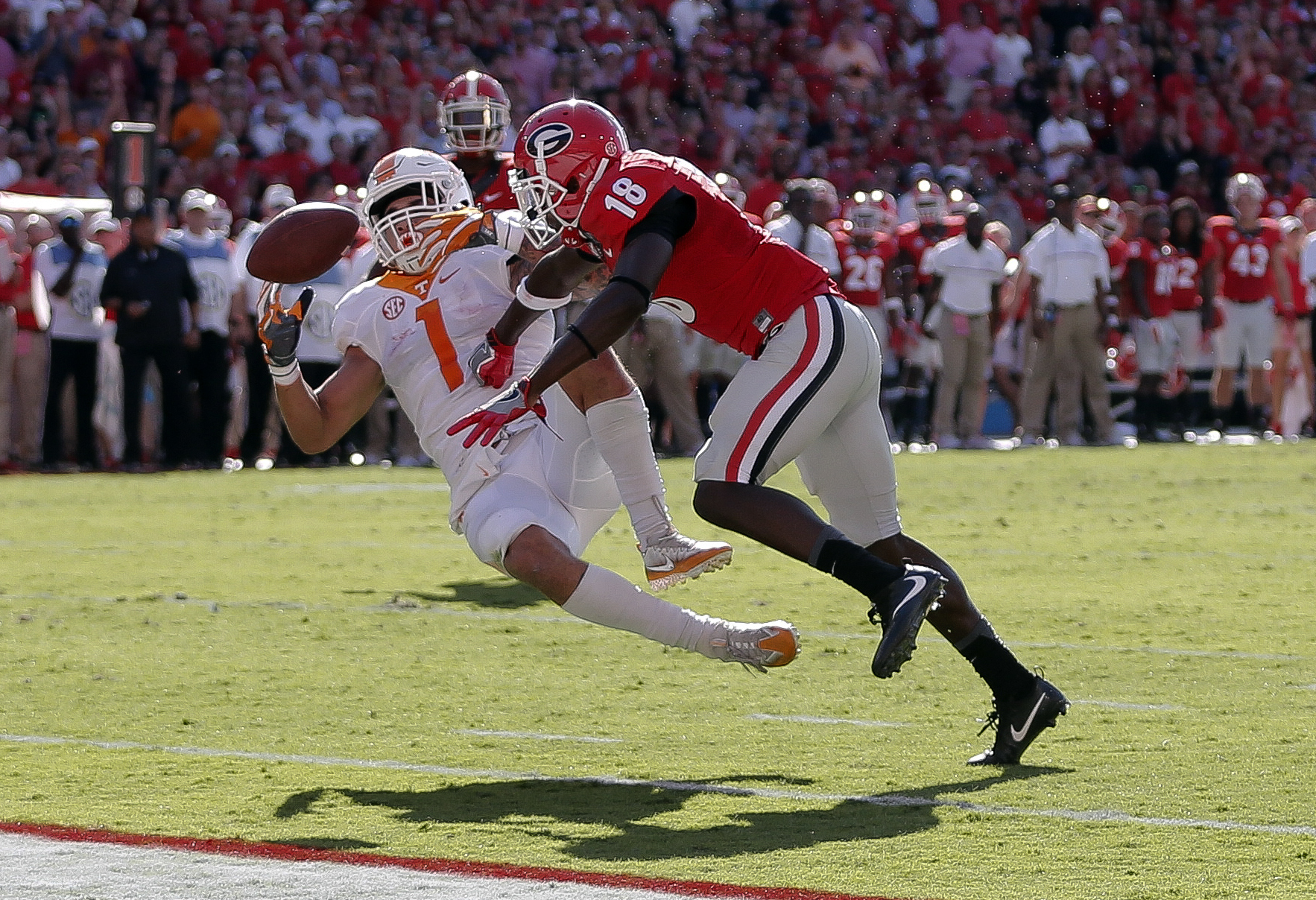 Tennessee running back Jalen Hurd (1) fumbles after being hit by Georgia cornerback Deandre Baker (18) in the first half of an NCAA college football game Saturday, Oct. 1, 2016, in Athens, Ga. Georgia recovered the ball in the end zone for a touchback. (AP Photo/John Bazemore)