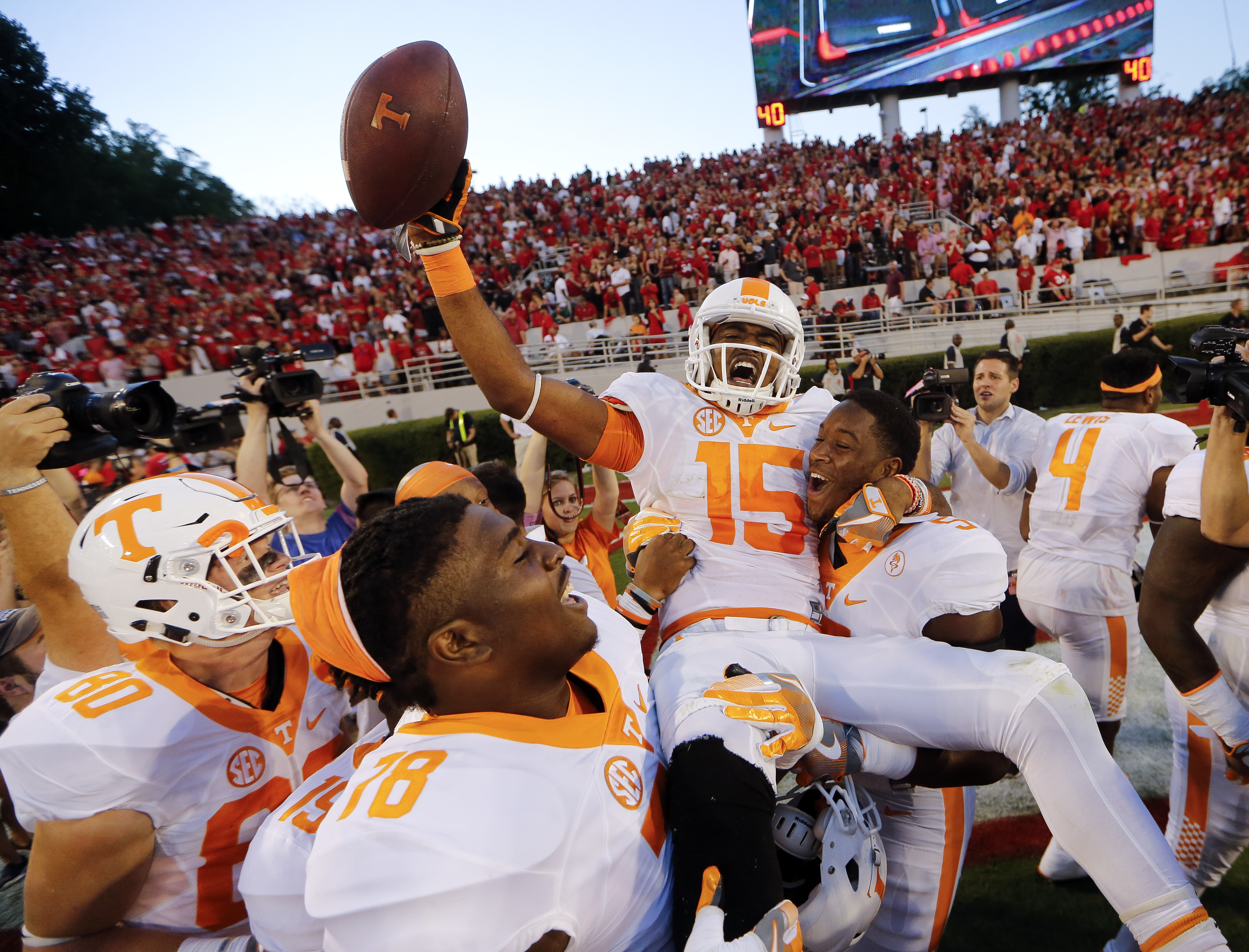 Tennessee wide receiver Jauan Jennings (15) is carried by teammates Kyle Phillips (5) and Charles Mosley (78) after making a last-second touchdown catch to defeat Georgia 34-31 in an NCAA college football game Saturday, Oct. 1, 2016, in Athens, Ga. (AP Photo/John Bazemore)