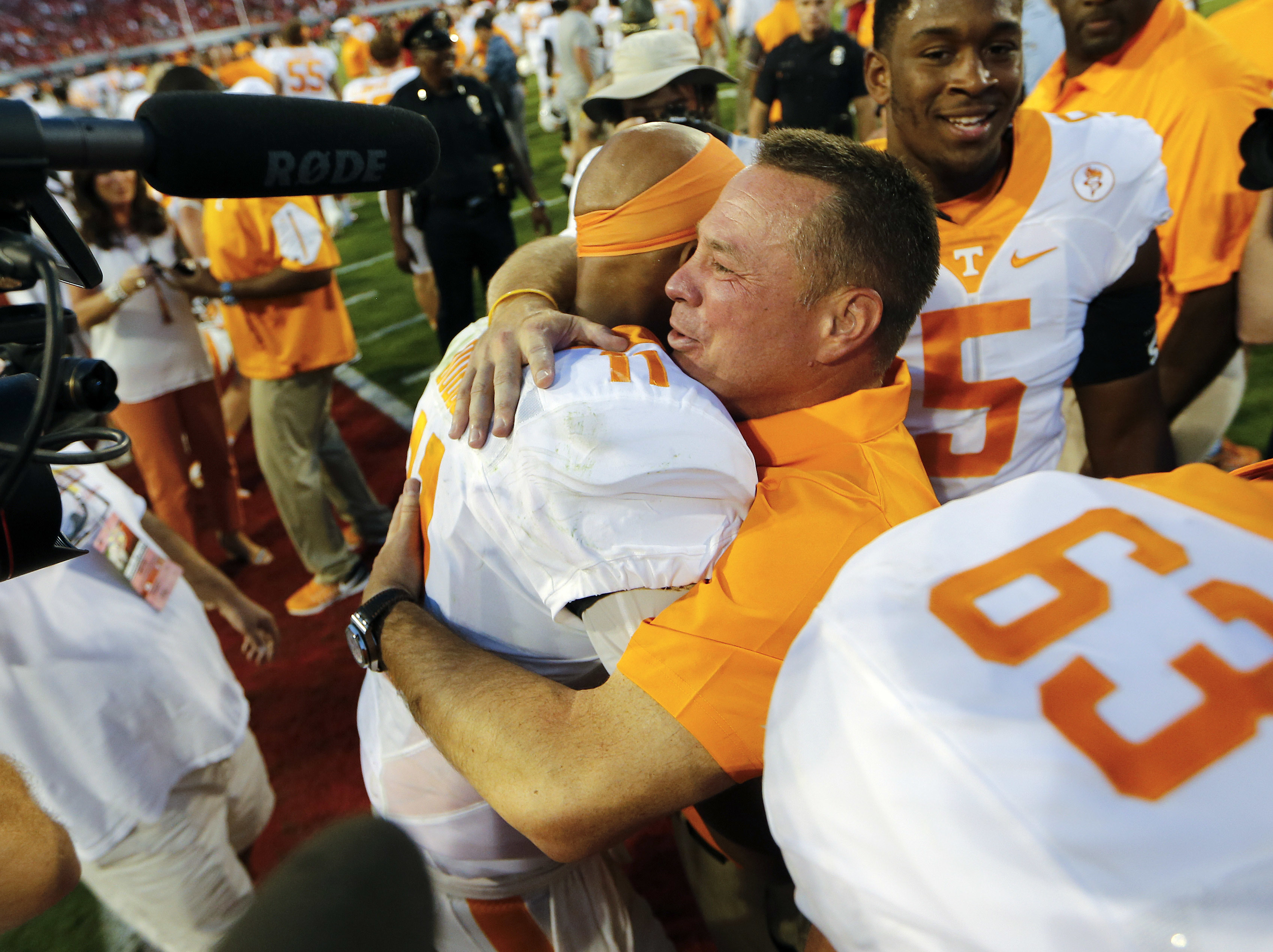Tennessee head coach Butch Jones hugs quarterback Joshua Dobbs (11) after defeating Georgia 34-31 in an NCAA college football game Saturday, Oct. 1, 2016, in Athens, Ga. Dobbs completed a last-second pass to wide receiver Jauan Jennings to give Tennessee the victory. (AP Photo/John Bazemore)