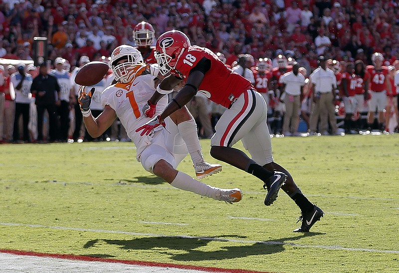Tennessee running back Jalen Hurd (1) fumbles after being hit by Georgia cornerback Deandre Baker (18) in the first half of an NCAA college football game Saturday, Oct. 1, 2016, in Athens, Ga. Georgia recovered the ball in the end zone for a touchback. (AP Photo/John Bazemore)