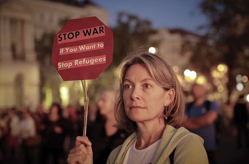 
              A woman holds a banner during a protest against Orban's policies regarding migrants in Budapest, Hungary, Friday, Sept. 30, 2016.  Hungarians will vote Sunday in a referendum which Prime Minister Viktor Orban hopes will give his government the popular support it seeks to oppose any future plans by the European Union to resettle asylum seekers among its member states. (AP Photo/Vadim Ghirda)
            