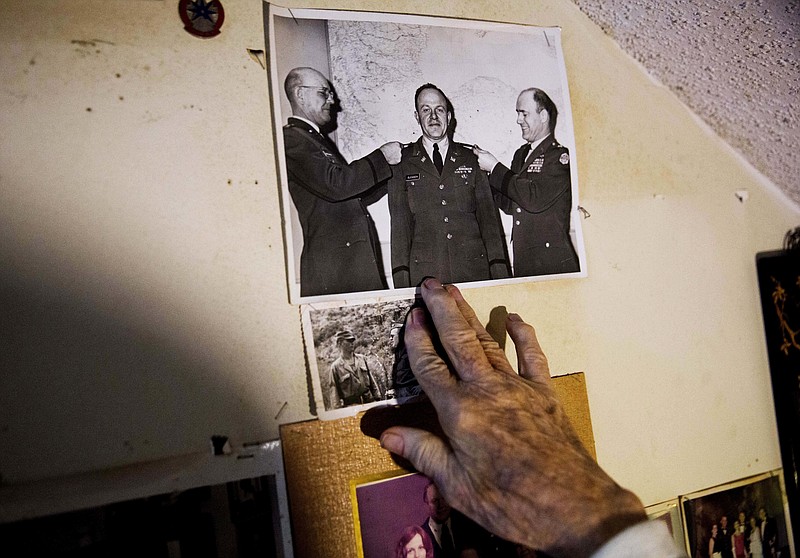 
              Memorabilia decorates a wall in the home of Frank Gleason, 96, a retired colonel with the Office of Strategic Services, in Atlanta, Wednesday, Sept. 28, 2016. Legislation to recognize the contributions of a group of World War II spies is hung up in Congress. Some 75 years ago, the OSS carried out missions behind enemy lines in Nazi Germany and the Pacific theatre. Gleason's group was tasked with halting the Japanese advance into China. Gleason and his comrades did this by detonating bridges, railroad tracks and anything else. 'We just blew stuff up left and right,' said Gleason. (AP Photo/David Goldman)
            