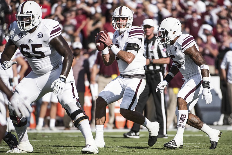 Texas A&M quarterback Trevor Knight, center, looks for a passing lane during the first half of an NCAA college football game against South Carolina, Saturday, Oct. 1, 2016, in Columbia, S.C. (AP Photo/Sean Rayford)