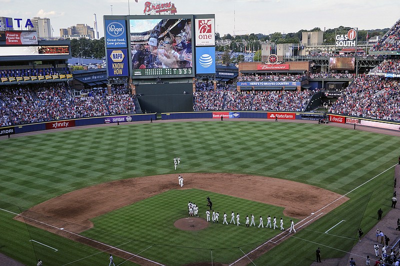 Atlanta Braves players take the field after winning their final baseball game at Turner Field, against the Detroit Tigers, Sunday, Oct. 2, 2016, in Atlanta. The franchise is planning on starting next season at SunTrust Park which is under construction in Cobb County. (AP Photo/John Amis)


