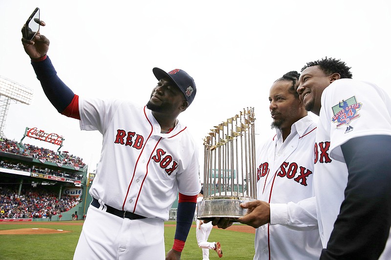 
              Boston Red Sox's David Ortiz, left, takes a selfie with former teammates Manny Ramirez, center, and Pedro Martinez following a ceremony to honor Ortiz before a baseball game against the Toronto Blue Jays in Boston, Sunday, Oct. 2, 2016. (AP Photo/Michael Dwyer)
            