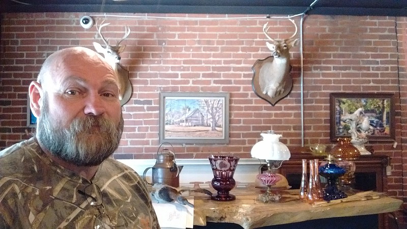 Bear Meadows shows off some of the wares available at Burlap & Board Antiques and More.