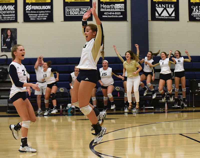 Soddy-Daisy's Cameren Swafford leaps into the air and celebrates with Kyleigh Ward (2) upon defeating East Hamilton in the first round of the District 5-AAA volleyball tournament Monday at Walker Valley.