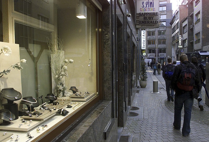 
              FILE - A  Monday, Feb. 24, 2003 photo from files showing people passing a jewelry store in the diamond quarter in Antwerp, Belgium. Authorities arrested three Italians and a Dutchwoman in connection with the plundering of 123 maximum-security vaults in the precious gem district the world capital of diamond-cutting, getting away with an estimated $100 million in goods. Kim Kardashian West joined a line of victims of major jewel heists when armed robbers entered her Paris residence, chained her to bathroom furnishings and escaped with jewels worth an estimated $10 million Sunday Oct. 2, 2016. (AP Photo/Yves Logghe, File)
            