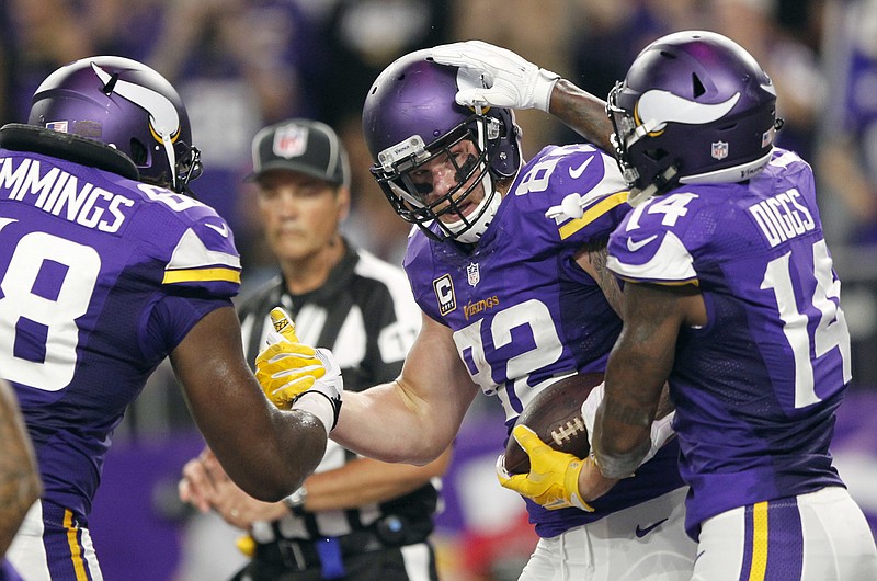 Minnesota Vikings tight end Kyle Rudolph, center, celebrates with teammates T.J. Clemmings, left, and Stefon Diggs, right, after catching a 7-yard touchdown pass during the first half of an NFL football game against the New York Giants on Monday, Oct. 3, 2016, in Minneapolis.