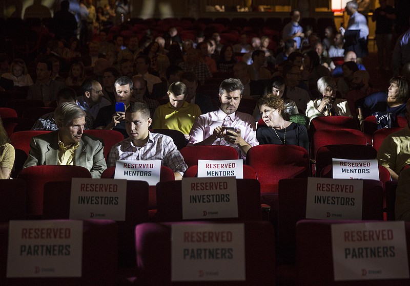 People gather to watch businesses pitch their ideas at the Dynamo Demo Day event at the Tivoli Theater on Tuesday, Oct. 4, 2016, in Chattanooga, Tenn. 10 logistics startup companies which took part in a 12-week startup accelerator program pitched their plans at the event.