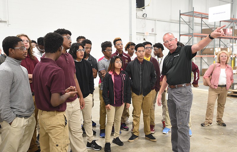 Ladair Tinker, second from right, gets ready to lead a group of students on a  tour of the Gestamp plant Tuesday, Oct. 4, 2016.