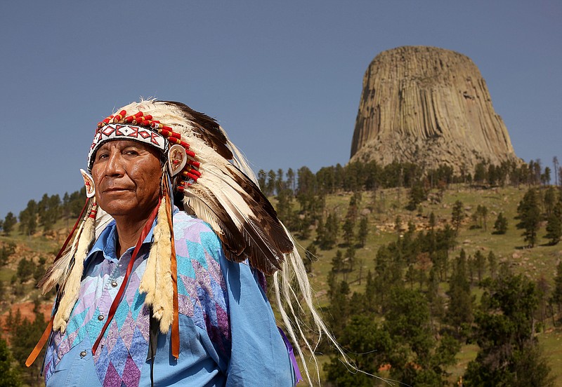 
              FILE - This Thursday, July 9, 2015 file photo shows Chief Arvol Looking Horse, spiritual leader of the Great Sioux Nation, posing for a portrait in front of Devils Tower National Monument in Devils Tower, Wyo. As the nation's first national monument approaches its 110th anniversary in 2016, Arvol Looking Horse has petitioned to change the name of the geologic feature to Bear Lodge and the name of the monument to Bear Lodge National Monument. Opponents of the idea say changing the name would cause confusion and hurt tourism. (Dan Cepeda/The Casper Star-Tribune via AP, File)
            