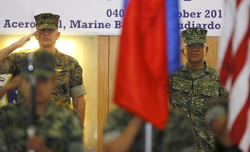 U.S. Marines Brig. Gen. John Jansen of the 3rd Marine Expeditionary Brigade and Maj. Gen. Andre Costales, Commandant of the Philippine Marines Corps, salute the flags at the opening ceremony for the 33rd joint US-Philippines amphibious landing exercises dubbed PHIBLEX at the marines corps in Taguig city east of Manila, Philippines Tuesday Oct.4,2016. President Rodrigo Duterte said he was giving notice to the United States, his country's long-standing ally, that joint exercises between Filipino and American troops this week will be the last such drills. He told the Filipino community in Hanoi, Vietnam's capital, last week that he will maintain the military alliance with the U.S. because of the countries' 1951 defense treaty. But he said this week's exercises will proceed only because he did not want to embarrass his defense secretary.(AP Photo/Bullit Marquez)
