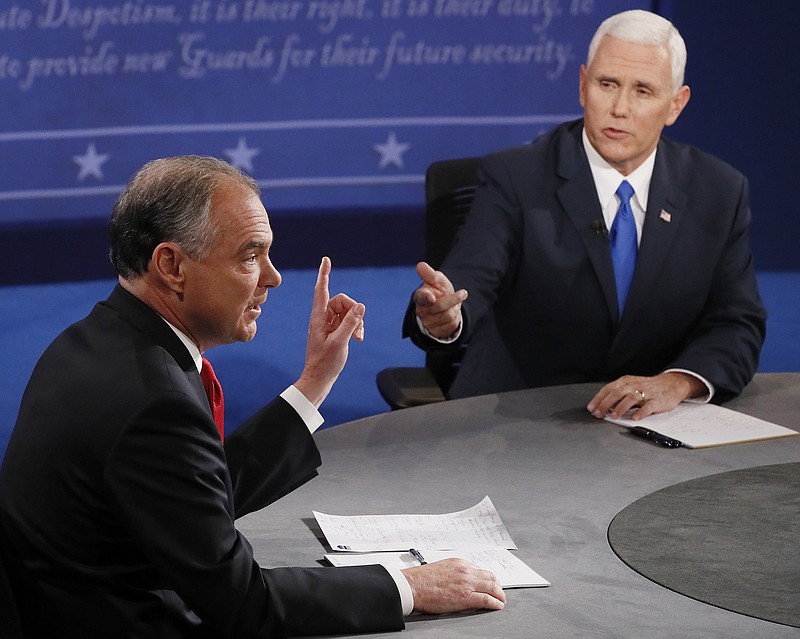 Republican vice-presidential nominee Gov. Mike Pence, right, and Democratic vice-presidential nominee Sen. Tim Kaine speak during the vice-presidential debate at Longwood University in Farmville, Va., Tuesday, Oct. 4, 2016. 
