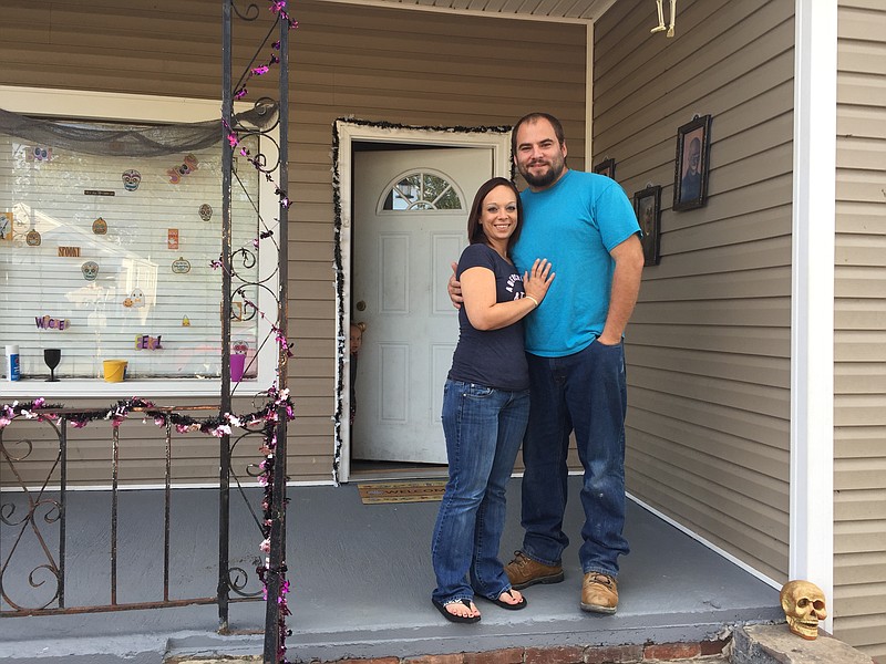 Tammy Harris and Justin Carroll stand outside their rental house in Rossville.