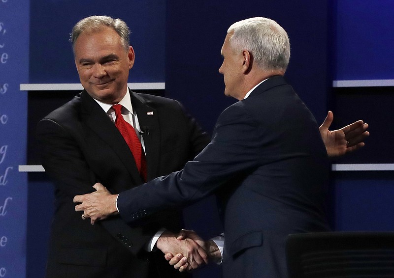 Republican vice-presidential nominee Gov. Mike Pence shakes hands with Democratic vice-presidential nominee Sen. Tim Kaine during the vice-presidential debate at Longwood University in Farmville, Va., Tuesday, Oct. 4, 2016. (AP Photo/Julio Cortez)