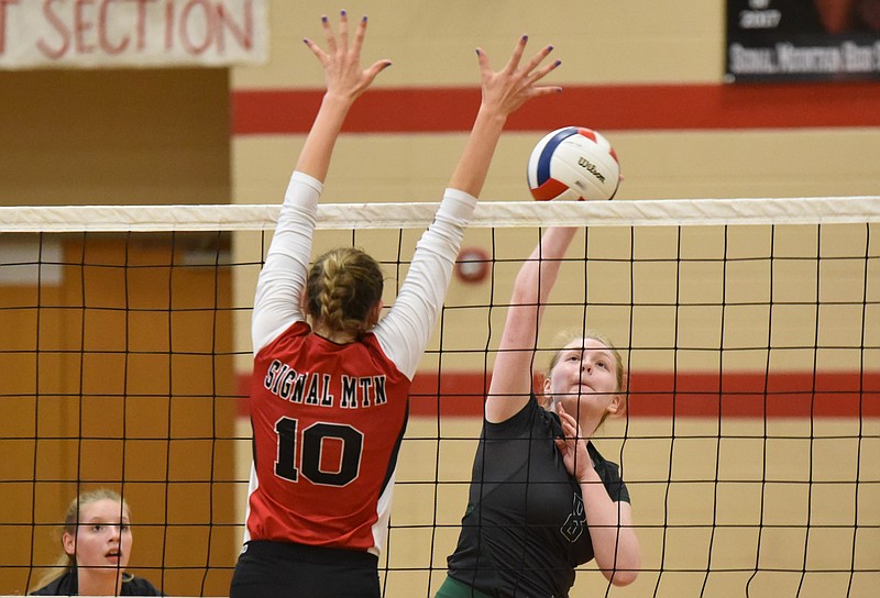 Notre Dame's Kyla Mitchell (8) takes a shot at the net early as Signal Mountain's Maia Rackel (10) defends during the  District 7-AA championship match at Signal Mountain on Thursday.