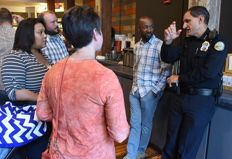 Chattanooga Police Chief Fred Fletcher, right, talks with community members Friday evening as they meet with police officers for the department's first "Coffee with a Cop' event at Goodman Expert Coffee Roasters in Warehouse Row. Community members clockwise from left are, Chanet Faber, Ian Goodman, Jeremy Faber, Fletcher and Dawn Coulter, left front center.
