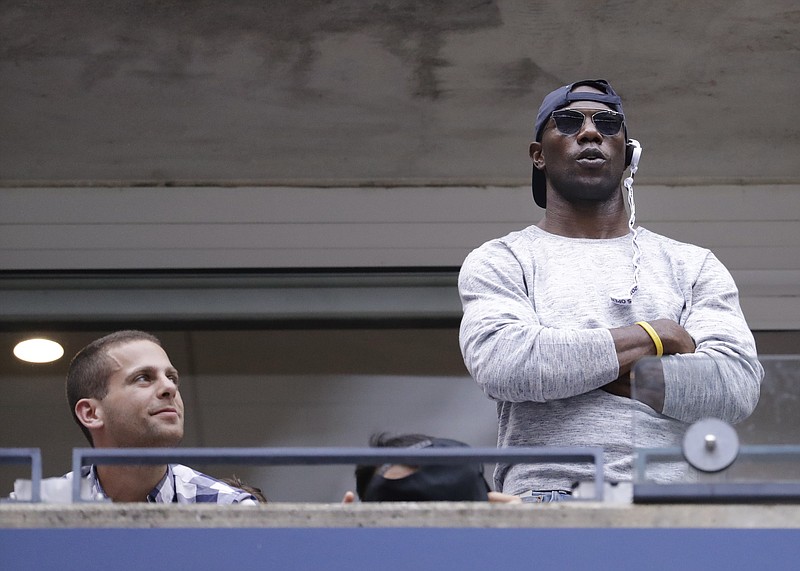 Former NFL player Terrell Owens watches play between Karolina Pliskova, of the Czech Republic, and Angelique Kerber, of Germany, during the women's singles final of the U.S. Open tennis tournament, Saturday, Sept. 10, 2016, in New York. (AP Photo/Julio Cortez)