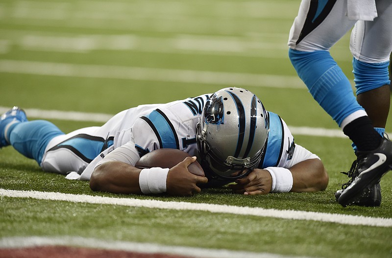 Carolina Panthers quarterback Cam Newton (1) lies on the turf after a hit during a two-point conversion against the Atlanta Falcons during the second half of an NFL football game, Sunday, Oct. 2, 2016, in Atlanta. (AP Photo/Rainier Ehrhardt)