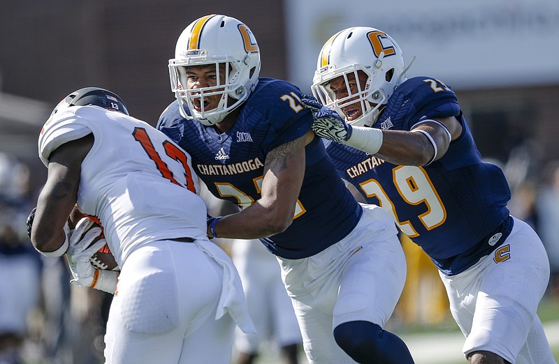UTC defensive backs Montrell Pardue (21) and Lucas Webb (29) tackle Mercer wide receiver Chandler Curtis during the Mocs' home football game against the Mercer Bears at Finley Stadium on Saturday, Oct. 8, 2016, in Chattanooga, Tenn.