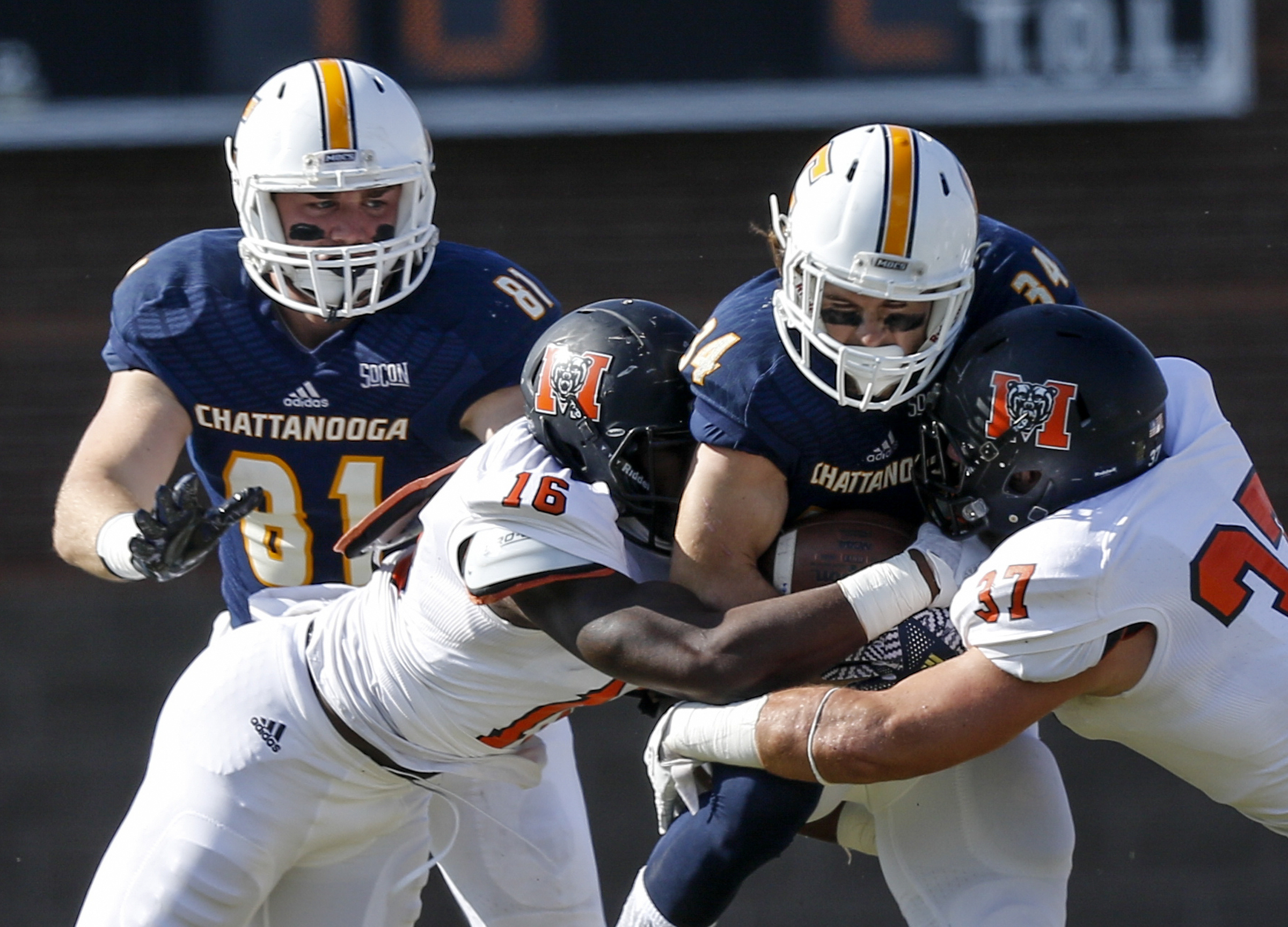 UTC running back Derrick Craine (34) pushes into Mercer linebackers LeMarkus Bailey (16) and Tyler Ward during the Mocs' home football game against the Mercer Bears at Finley Stadium on Saturday, Oct. 8, 2016, in Chattanooga, Tenn.