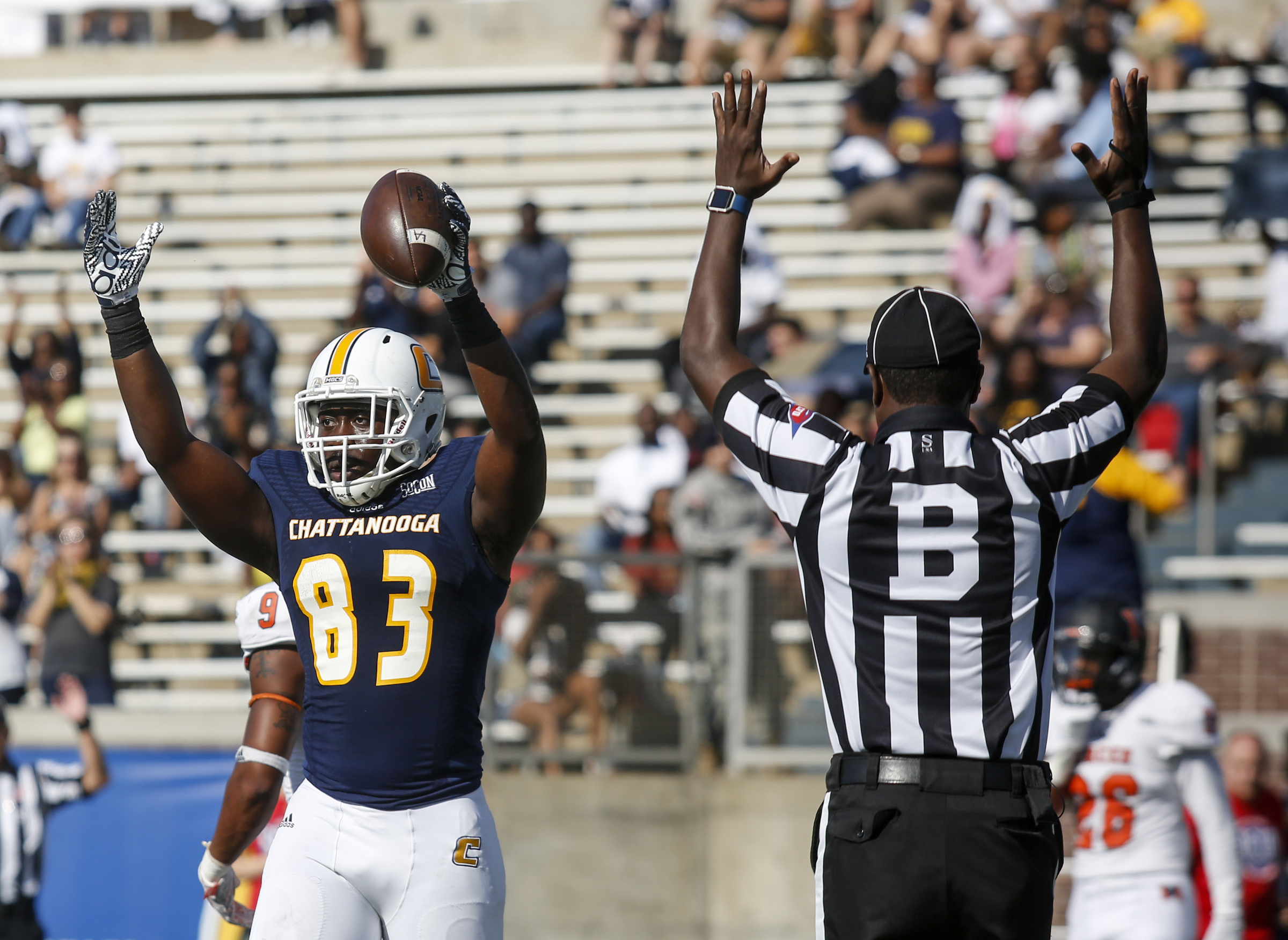 UTC tight end Malcolm Colvin signals a touchdown with back judge Jamal Shears after catching a pass in the end zone during the Mocs' home football game against the Mercer Bears at Finley Stadium on Saturday, Oct. 8, 2016, in Chattanooga, Tenn.