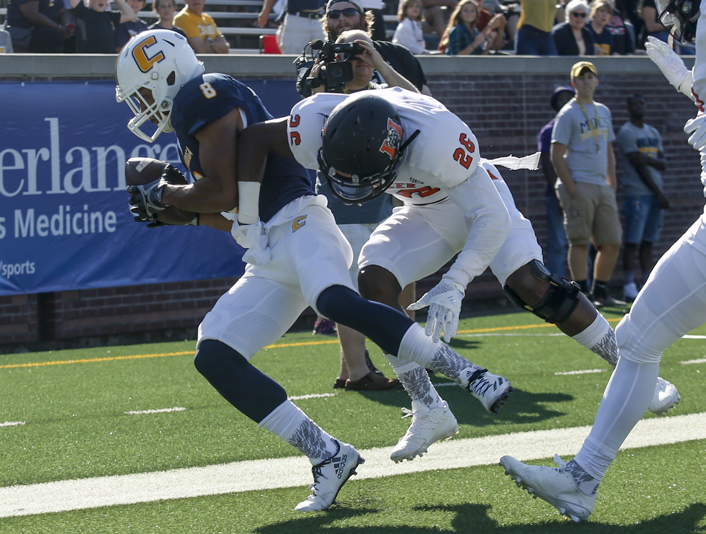 UTC wide receiver C.J. Board catches a pass in the end zone ahead of Mercer defensive back Jeremy James for a touchdown during the Mocs' home football game against the Mercer Bears at Finley Stadium on Saturday, Oct. 8, 2016, in Chattanooga, Tenn.