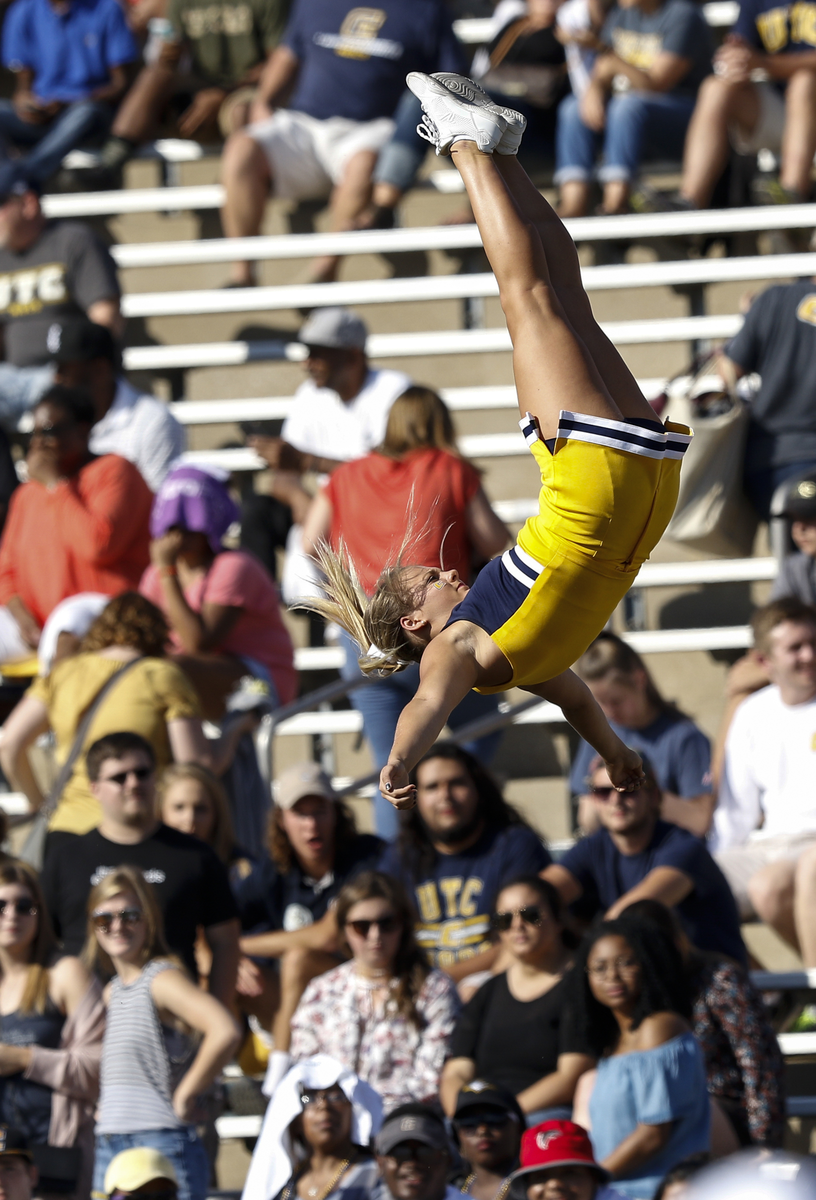 A UTC cheerleader is tossed into the air during the Mocs' home football game against the Mercer Bears at Finley Stadium on Saturday, Oct. 8, 2016, in Chattanooga, Tenn.