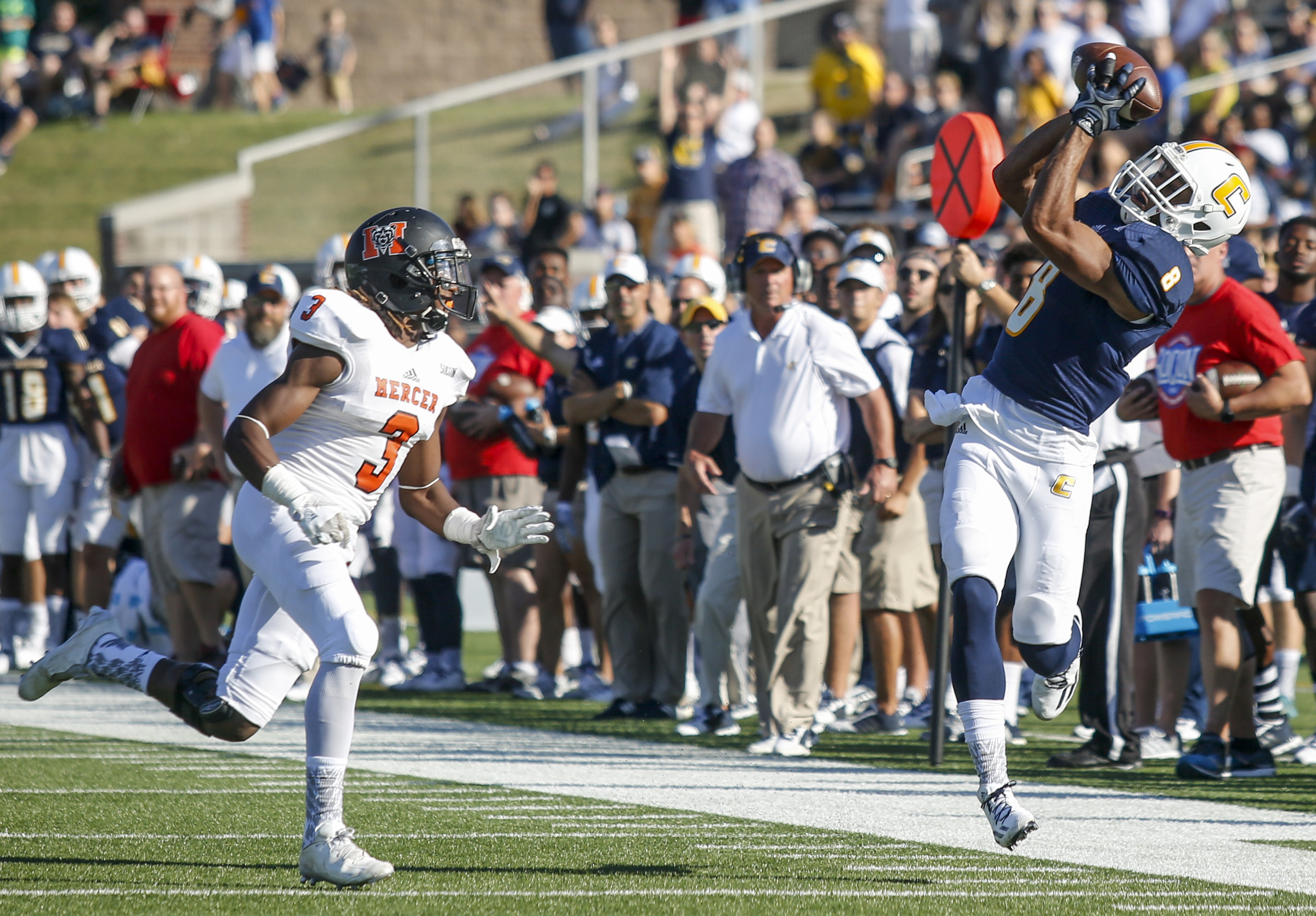 UTC wide receiver C.J. Board passes a pass ahead of Mercer defensive back Stephen Houzah during the Mocs' home football game against the Mercer Bears at Finley Stadium on Saturday, Oct. 8, 2016, in Chattanooga, Tenn.