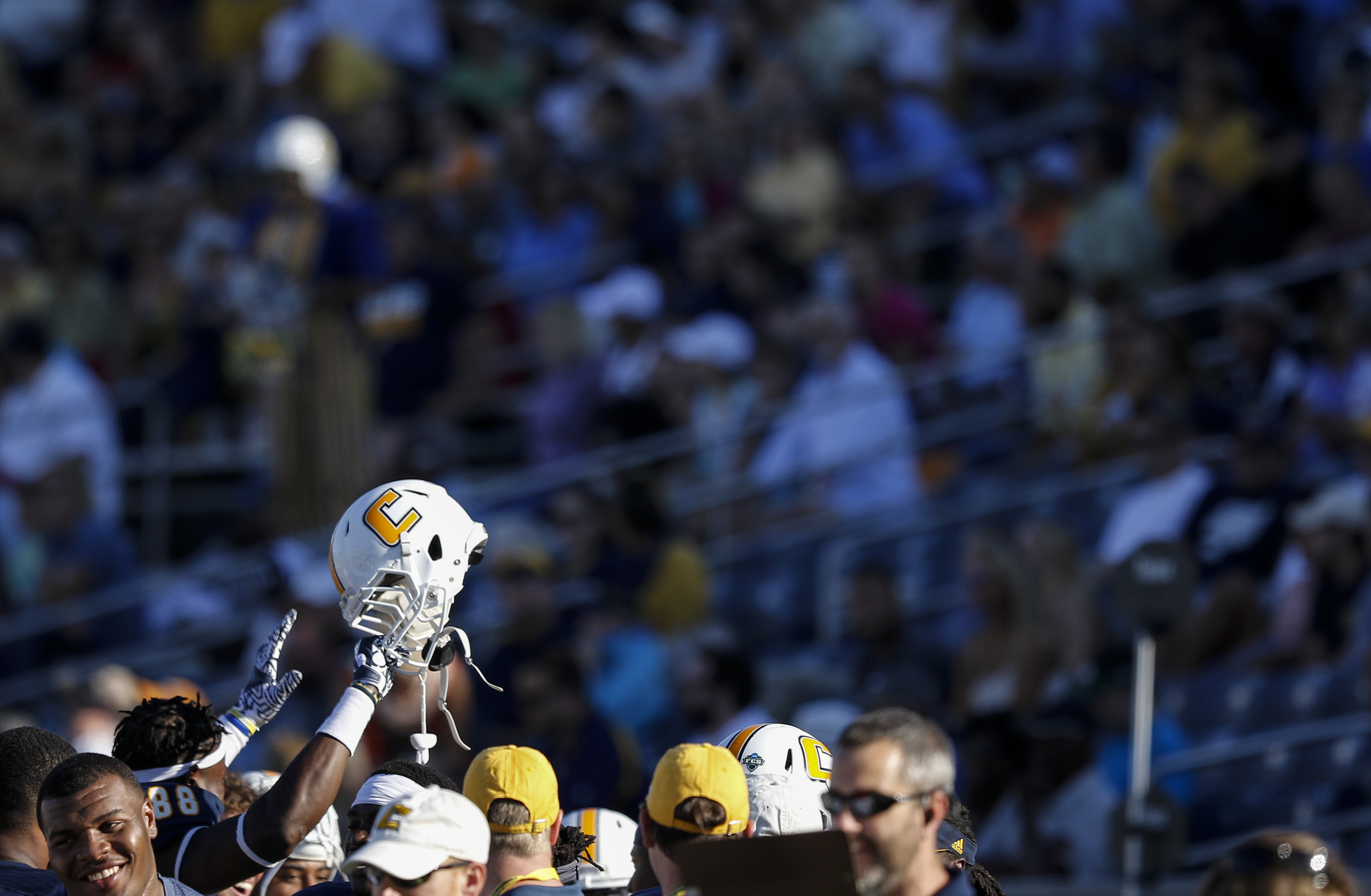 UTC defensive lineman Joshua Phillips raises his helmet in the air on the sidelines during the Mocs' home football game against the Mercer Bears at Finley Stadium on Saturday, Oct. 8, 2016, in Chattanooga, Tenn.