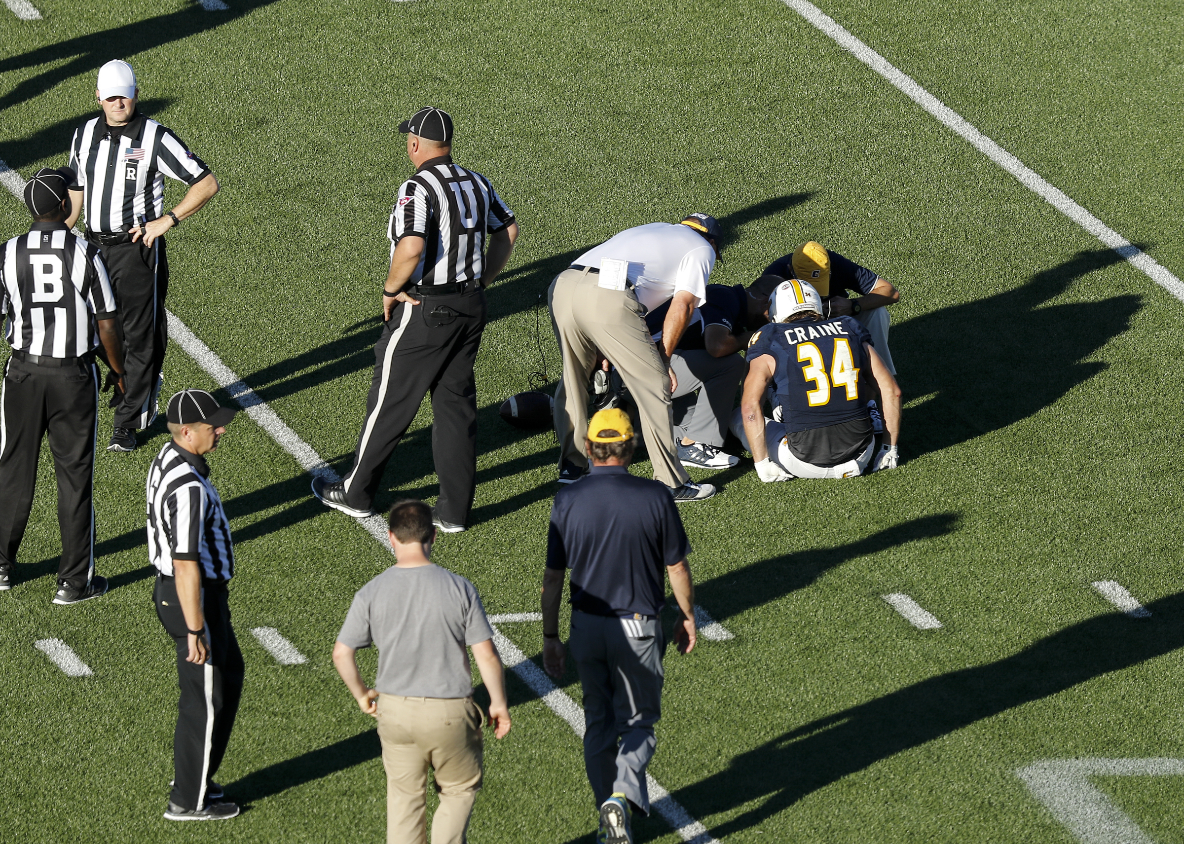 Officials attend UTC running back Derrick Craine after an injury during the Mocs' home football game against the Mercer Bears at Finley Stadium on Saturday, Oct. 8, 2016, in Chattanooga, Tenn.