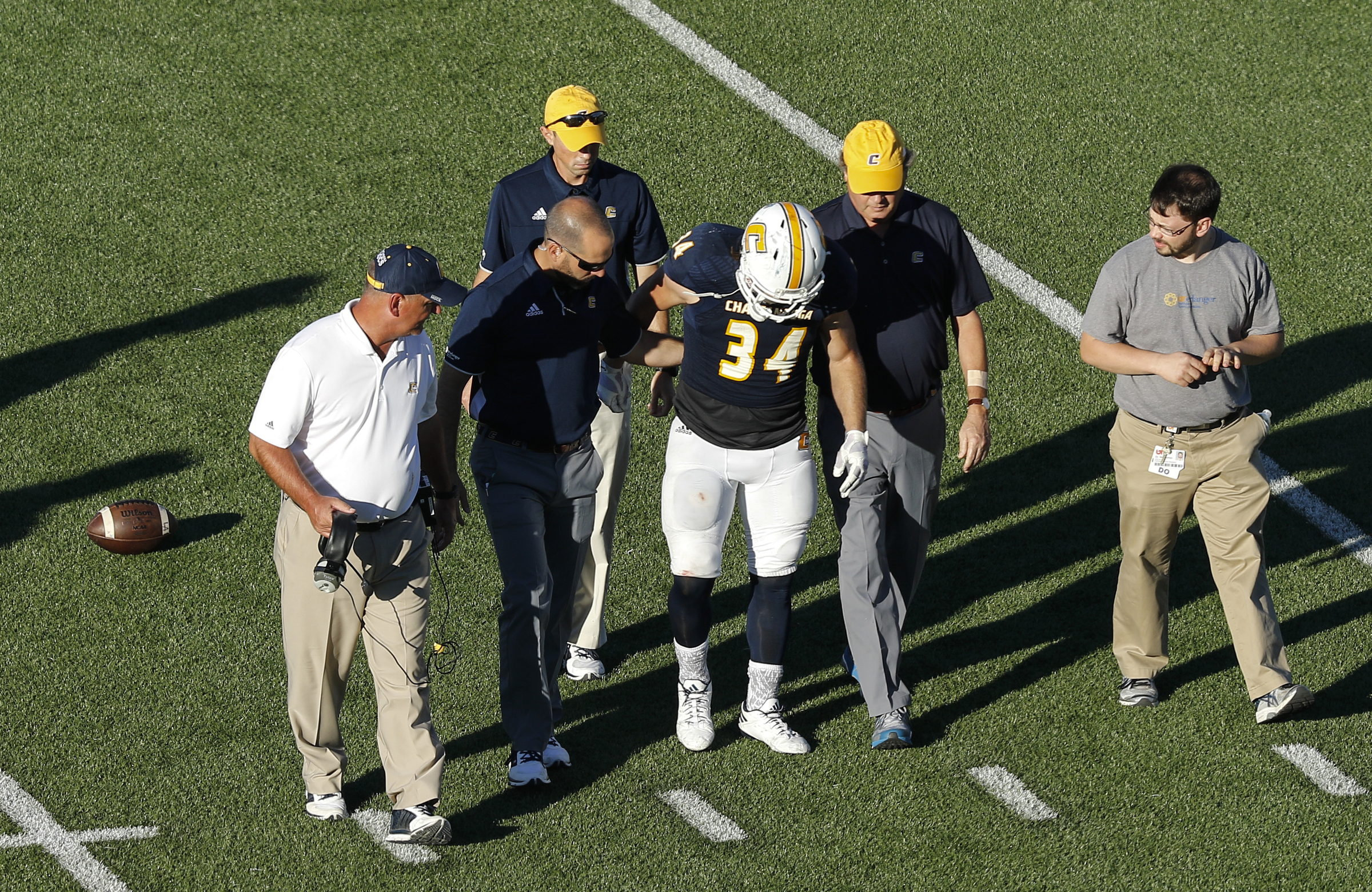 UTC running back Derrick Craine is helped off the field after an injury during the Mocs' home football game against the Mercer Bears at Finley Stadium on Saturday, Oct. 8, 2016, in Chattanooga, Tenn.
