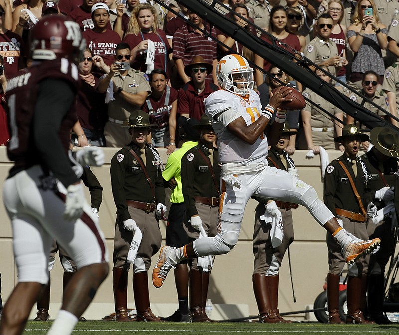 Tennessee's Joshua Dobbs (11) catches a pass for a touchdown during the first half of an NCAA college football game against Texas A&M Saturday, Oct. 8, 2016, in College Station, Texas. (AP Photo/David J. Phillip)