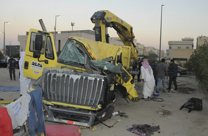 
              In this Saturday Oct. 8, 2016 photo released by Kuwait Ministry of Interiors, a damaged garbage truck after it rammed into another truck carrying five U.S. soldiers in Kuwait. An Egyptian driving a garbage truck loaded with explosives and Islamic State papers rammed into a truck carrying five U.S. soldiers in Kuwait on Saturday, injuring only himself in the attack, authorities said. (Kuwait Ministry of Interiors via AP)
            