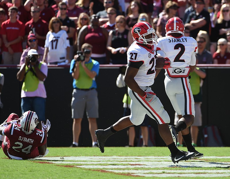 Georgia running back Nick Chubb (27) scores a touchdown against South Carolina during the first half of an NCAA college football game on Sunday, Oct. 9, 2016, in Columbia, S.C. (AP Photo/Rainier Ehrhardt)