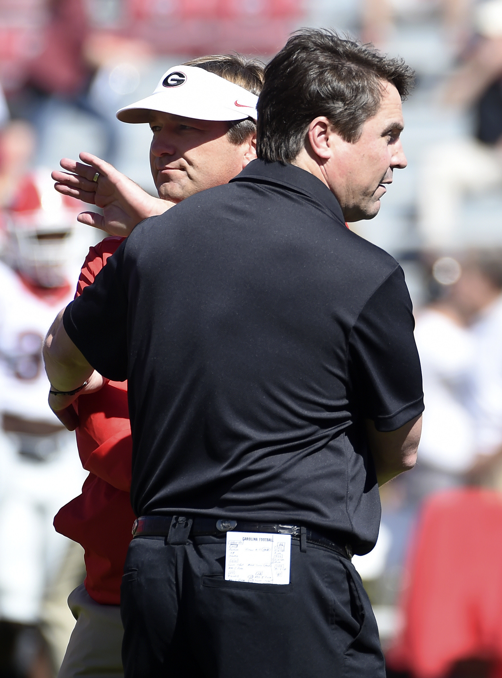 South Carolina head coach Will Muschamp, left, and Georgia head coach Kirby Smart meet on the field before an NCAA college football game on Sunday, Oct. 9, 2016, in Columbia, S.C. (AP Photo/Rainier Ehrhardt)