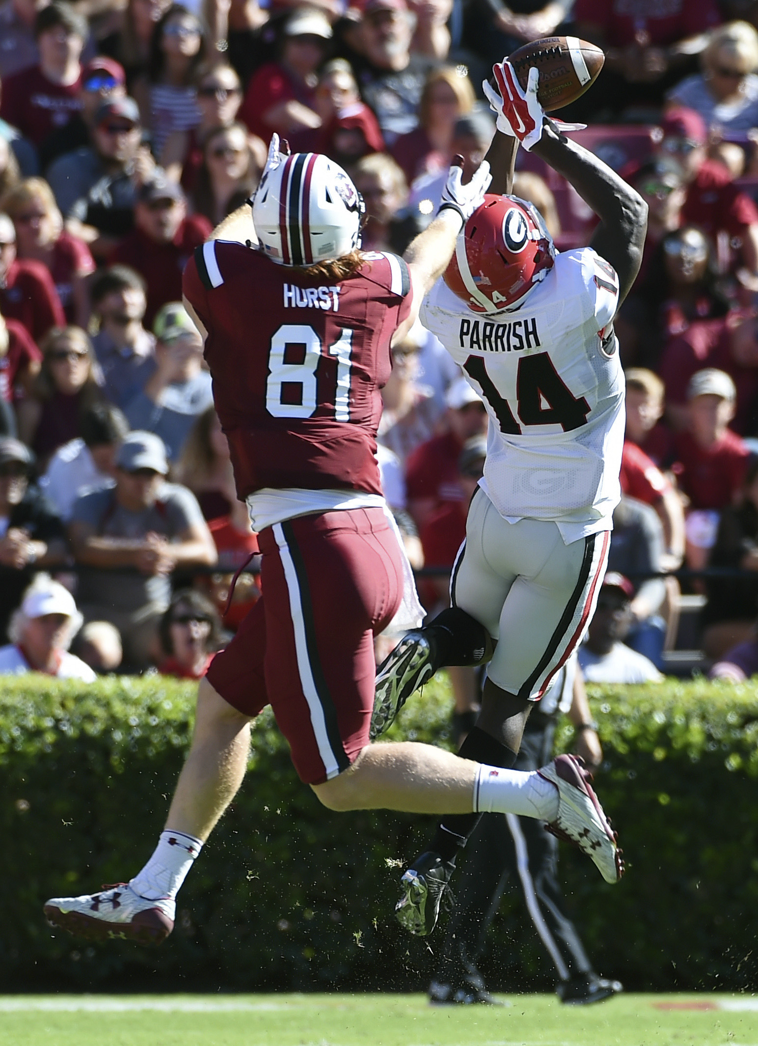 Georgia cornerback Malkom Parrish (14) intercepts a pass as South Carolina tight end Hayden Hurst (81) defends during the first half of an NCAA college football game on Sunday, Oct. 9, 2016, in Columbia, S.C. (AP Photo/Rainier Ehrhardt)