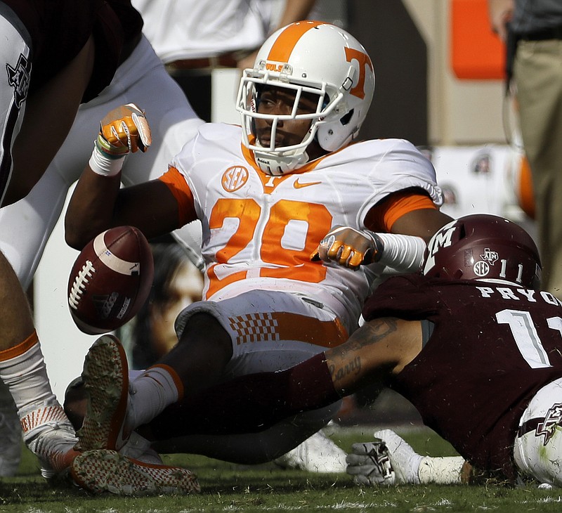 Tennessee kick returner Evan Berry fumbles after being hit by Texas A&M's Larry Pryor during Saturday's game in College Station, Texas. The Aggies, who recovered the ball on the play, won the game 45-38 in double overtime.