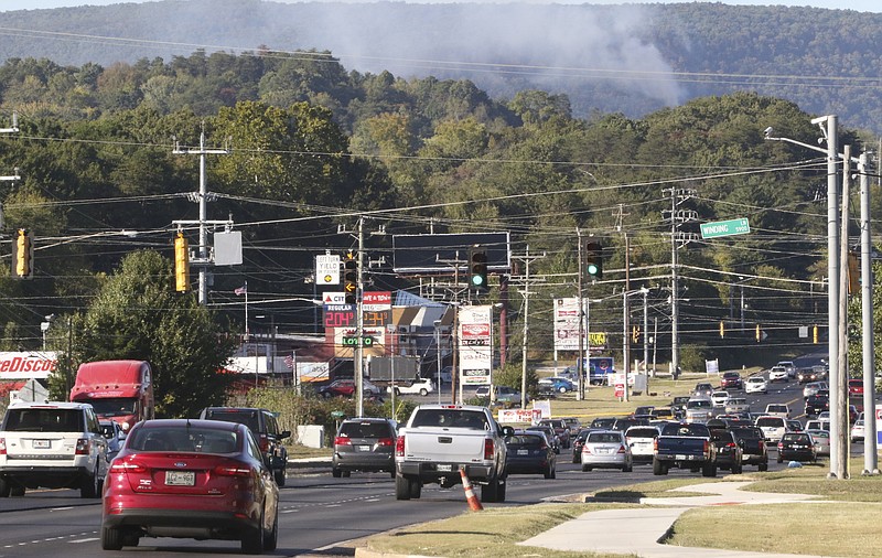 Staff Photo by Dan Henry / The Chattanooga Times Free Press- 10/9/16. A brush fire off in the distance near Roberts Mill Road that grew to 20 acres Saturday had fire crews responding again after resuming on Sunday, October 9, 2016. 
