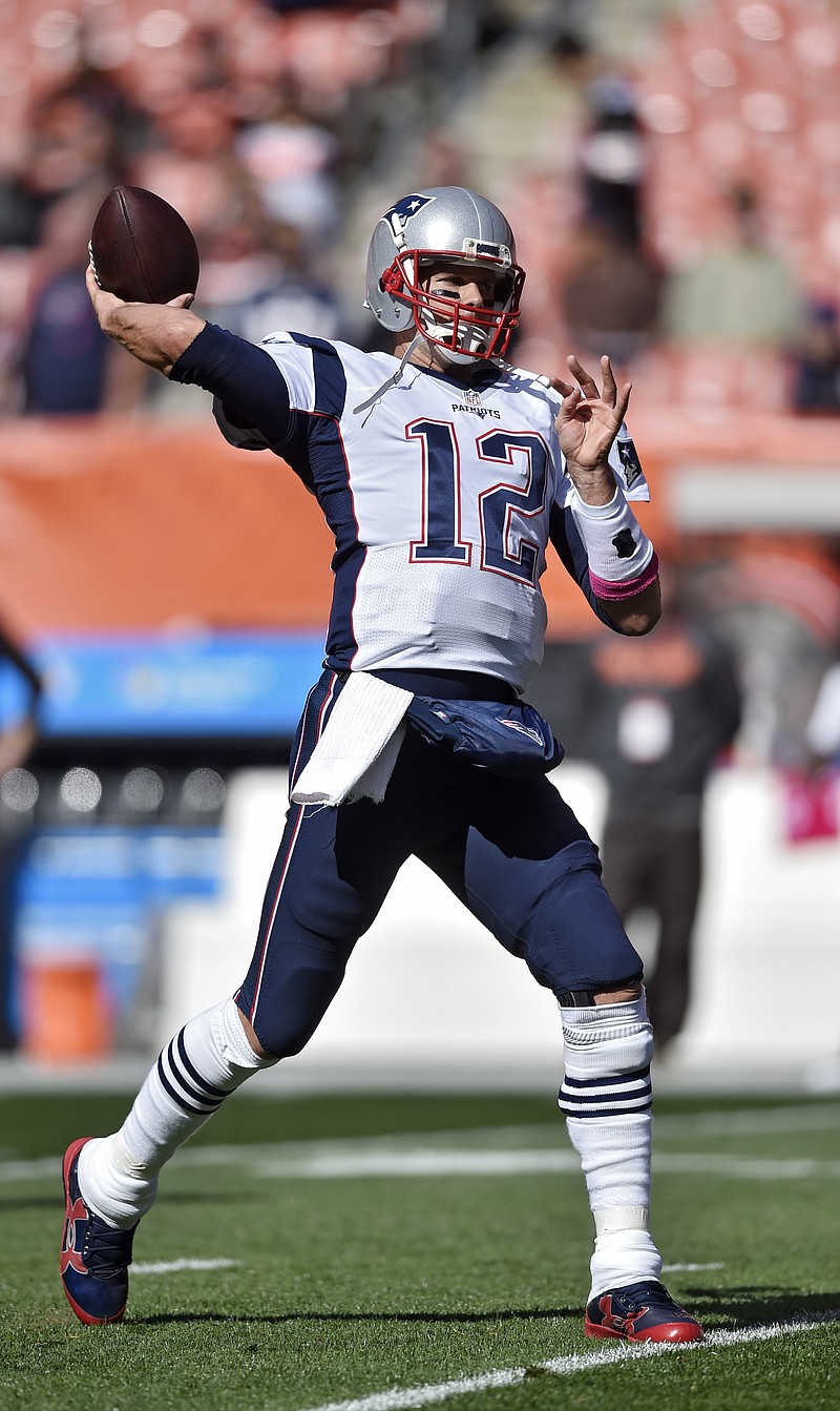 New England Patriots quarterback Tom Brady (12) chats with